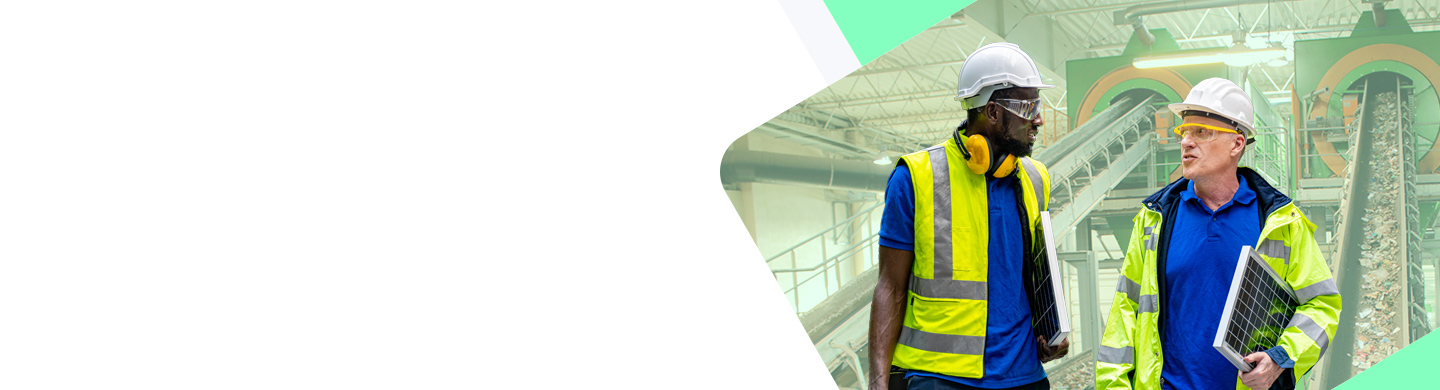 Two Men Wearing Safety Gear in a Waste Facility.